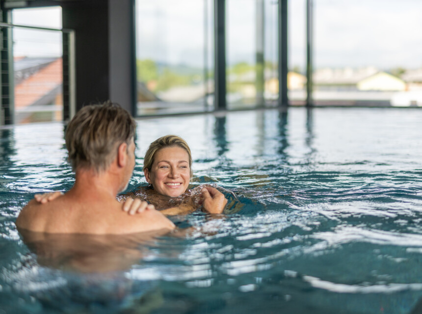 Ein Paar schwimmt im Panoramapool