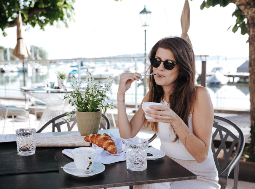 Eine Frau genießt das Frühstück im Hotel Seewirt Mattsee